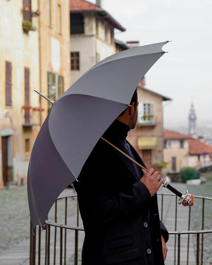 Grey men's umbrella with a hand-painted clown handle, showcasing Italian craftsmanship and elegant design.