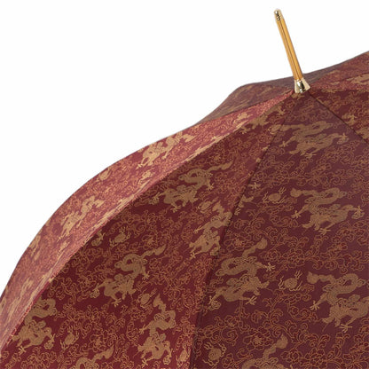 Luxury Pasotti burgundy umbrella showcasing golden dragon design and elegant Italian craftsmanship for men.