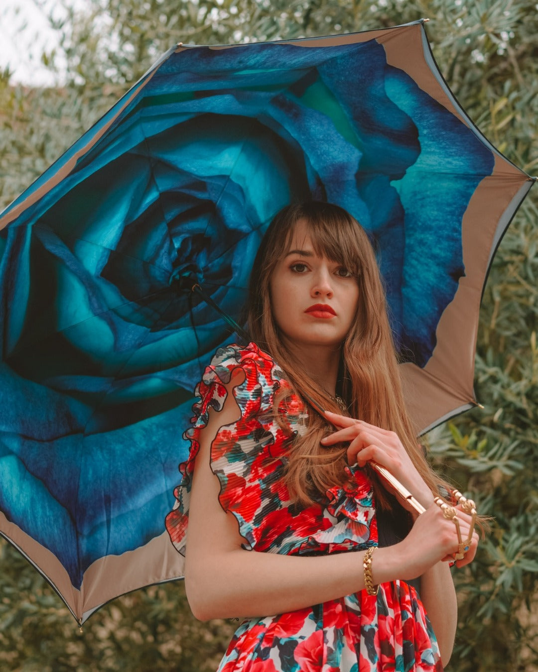 Elegant Italian handcrafted rain umbrella with gold handle and red crystal closure, designed for women.