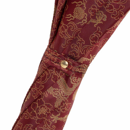 Pasotti Golden Dragons burgundy umbrella featuring a luxurious brass handle and elegant Italian craftsmanship.