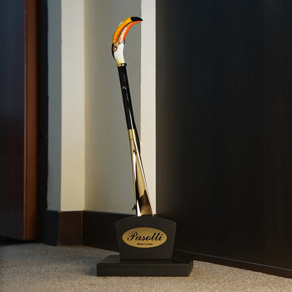 Handmade Pasotti toucan shoehorn with an enameled brass handle, showcasing intricate design and craftsmanship.